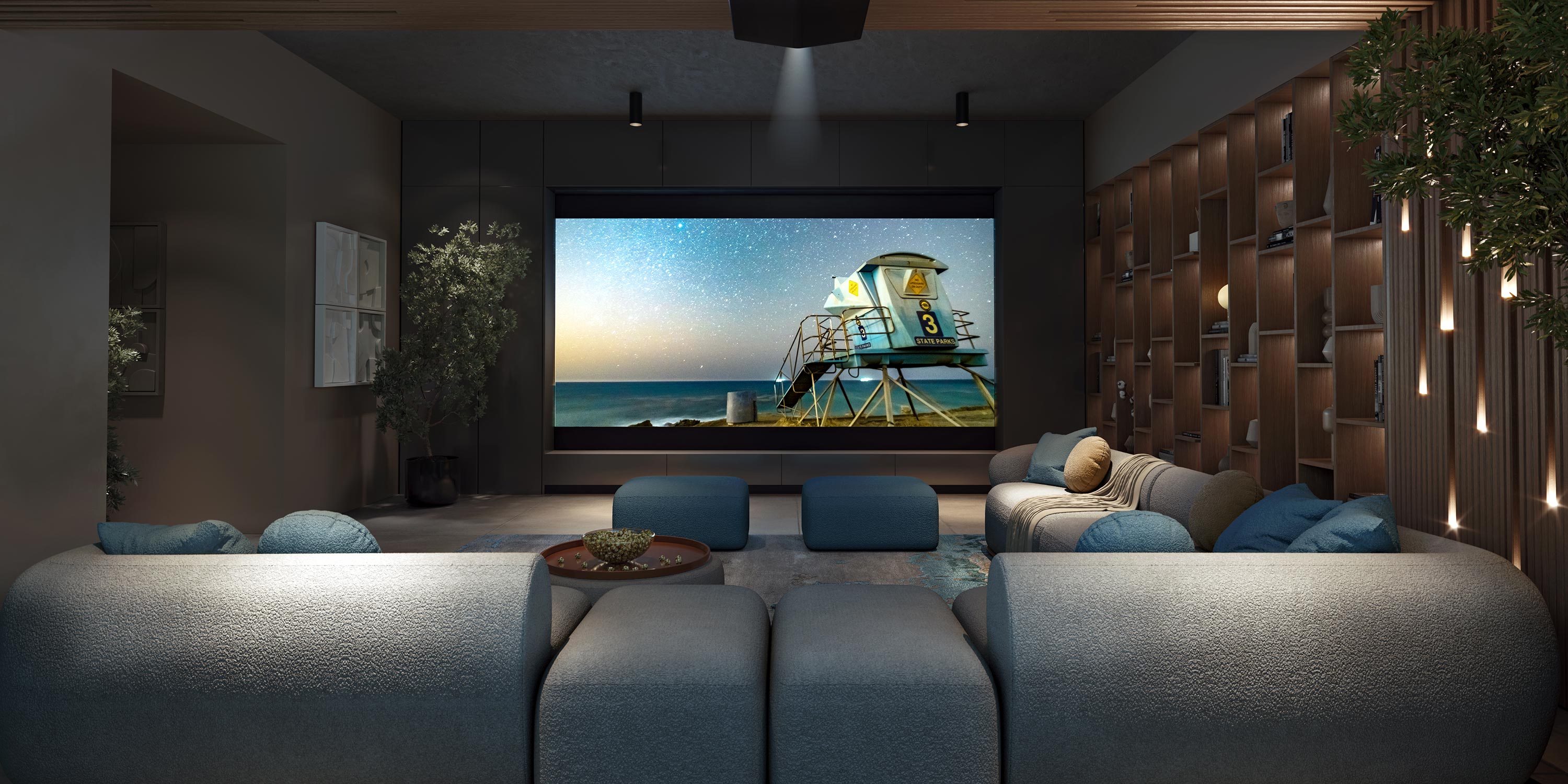 Luxurious home theater with large screen, blue sectional, and ambient lighting