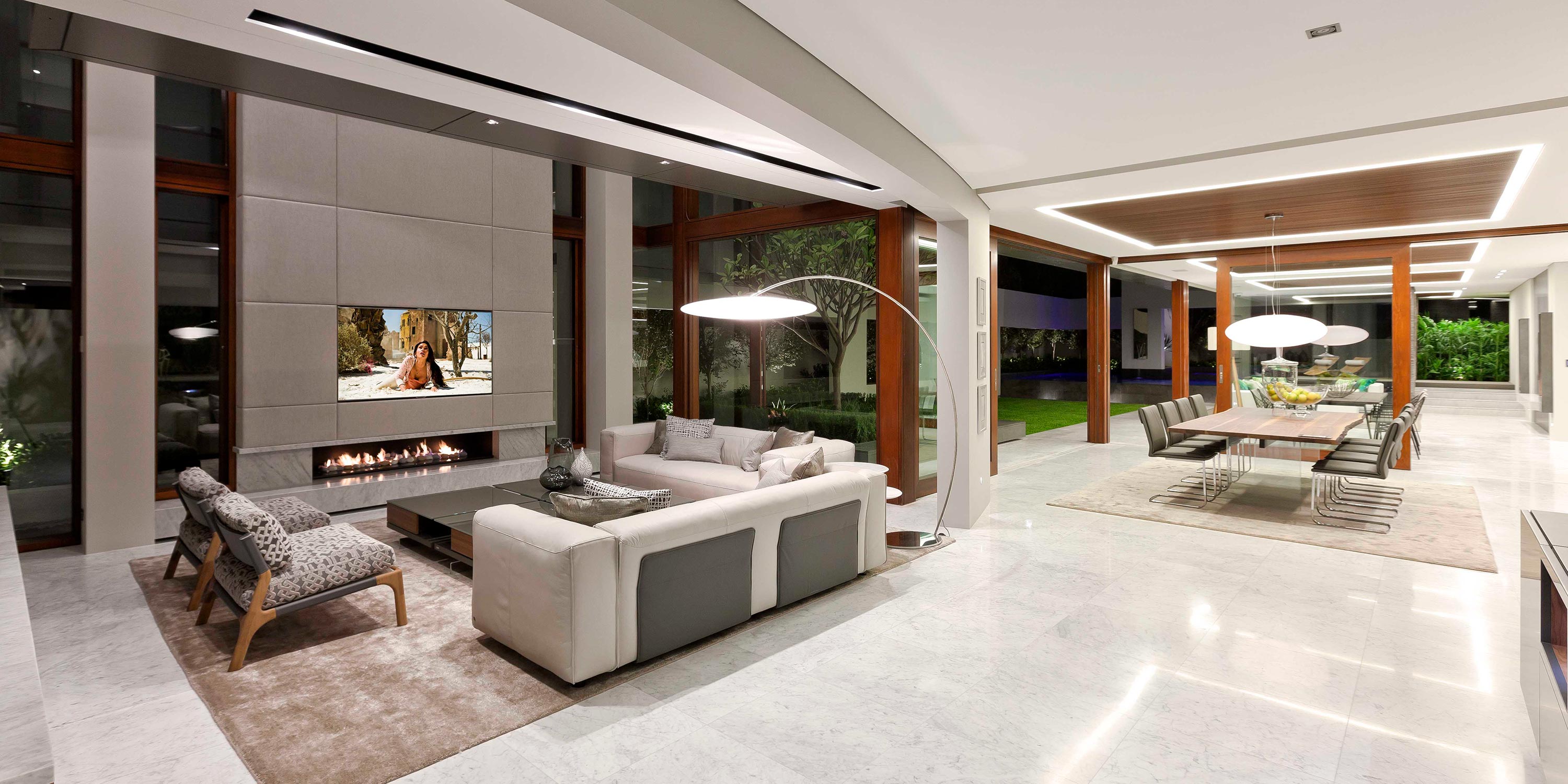 Expansive open-concept living and dining area with modern lighting and décor