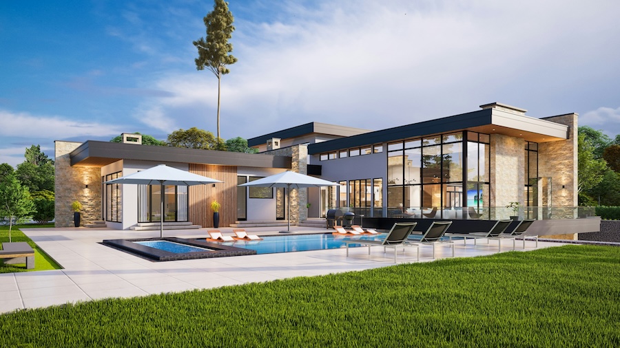 luxury home with a swimming pool, lounge chairs, and green lawn.