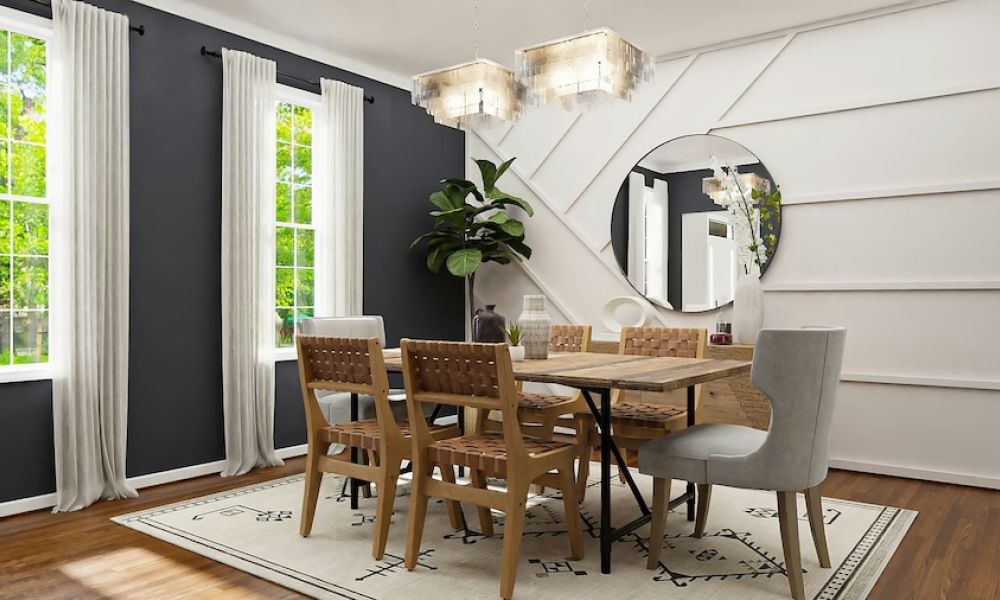 <span class="uk-h4">Dining room with wooden table, woven chairs, geometric accent wall, round mirror, and twin chandeliers</span>